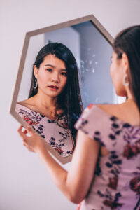 portrait of woman admiring herself in a mirror